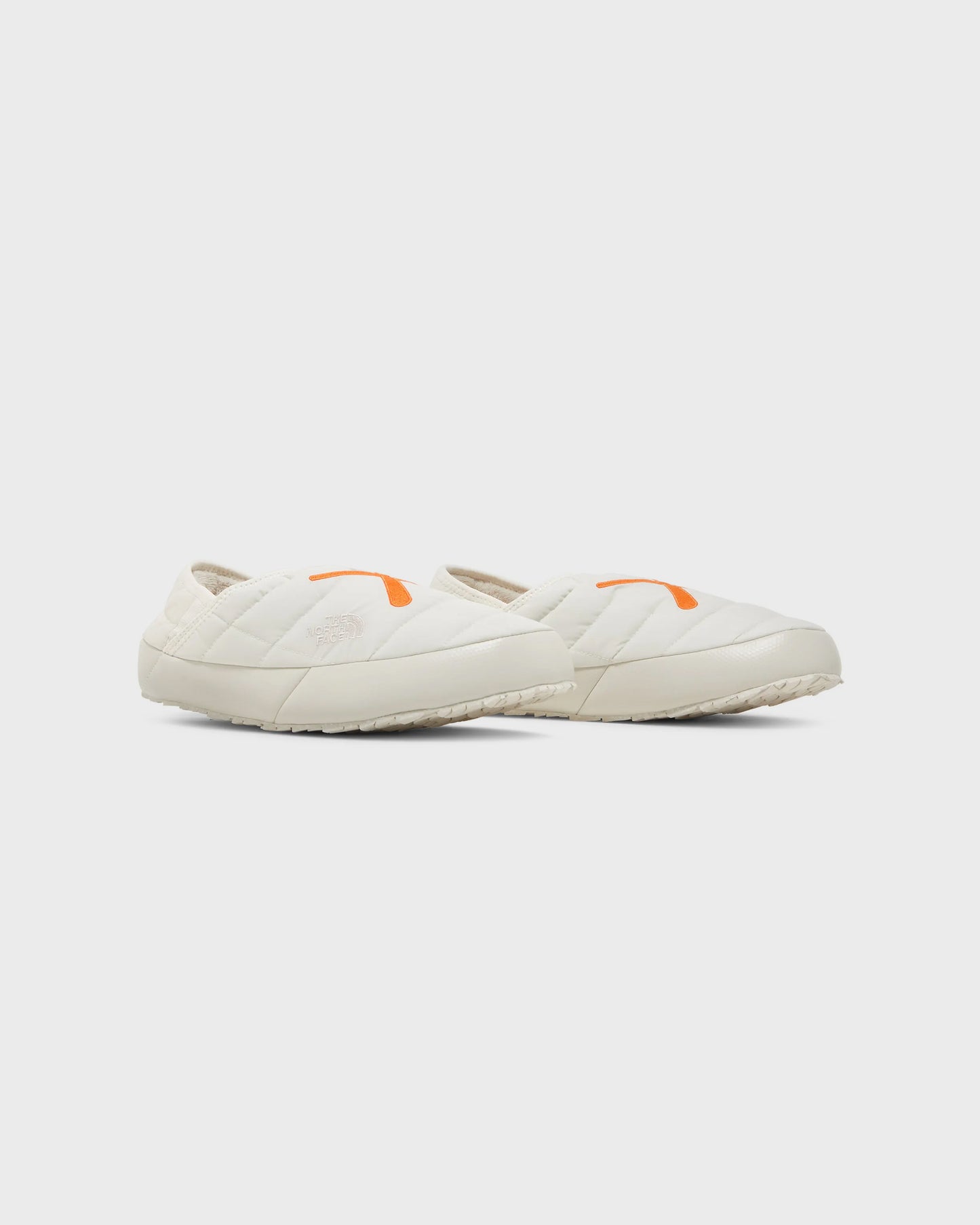 The North Face KAWS x ThermoBall Traction Mule VS Moonlight Ivory Orange